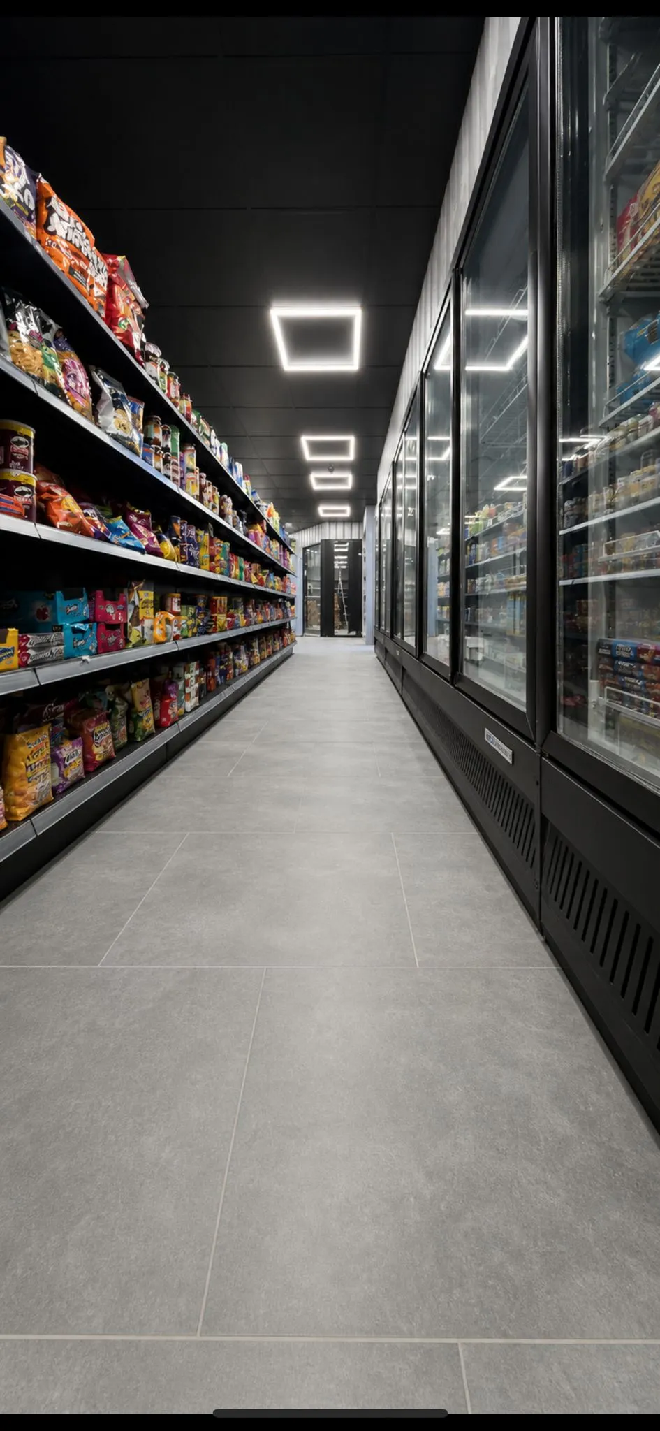 Convenience store fit-out interior with stocked snack aisle and chillers - by MG Fit-Out