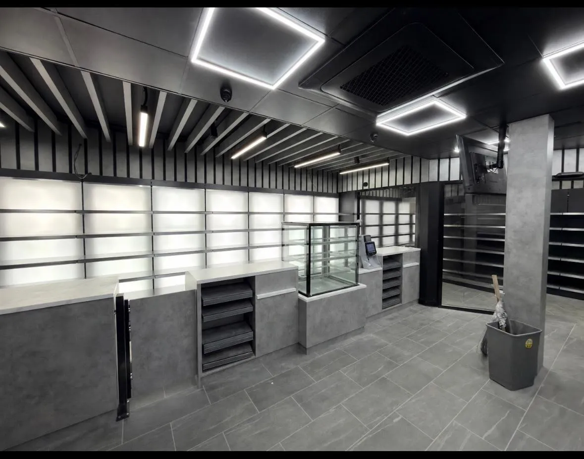 Premium convenience store fit-out interior - counter, display case, and slat ceiling by MG Fit-Out